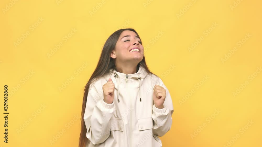Young cute woman raising fist, feeling happy and successful victory concept Young cute woman raising fist, feeling happy and successful victory concept