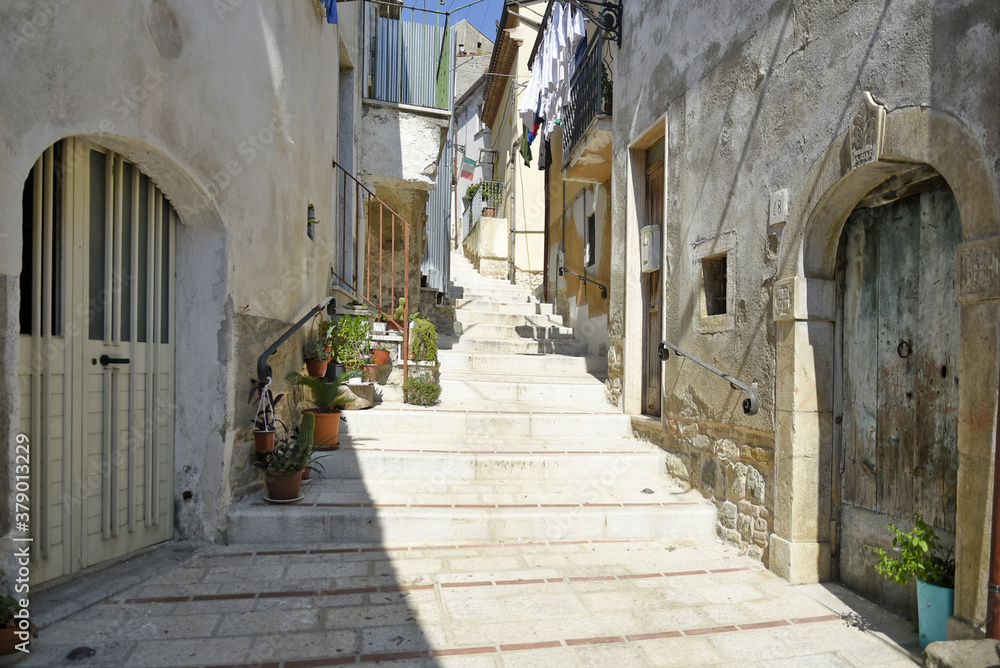 A narrow street among the old houses of San Bartolomeo in Galdo, a rural village in the Campania region, Italy.
