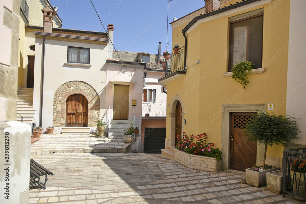 A narrow street among the old houses of San Bartolomeo in Galdo, a rural village in the Campania region, Italy.
