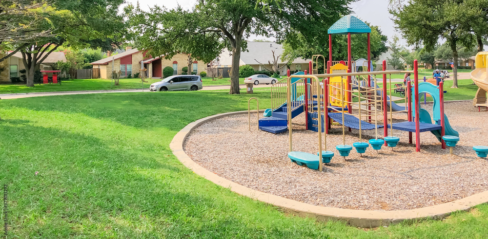 Colorful playground in green park near residential area in Richardson, Texas, USA Colorful playground in green park near residential area in Richardson, Texas, USA