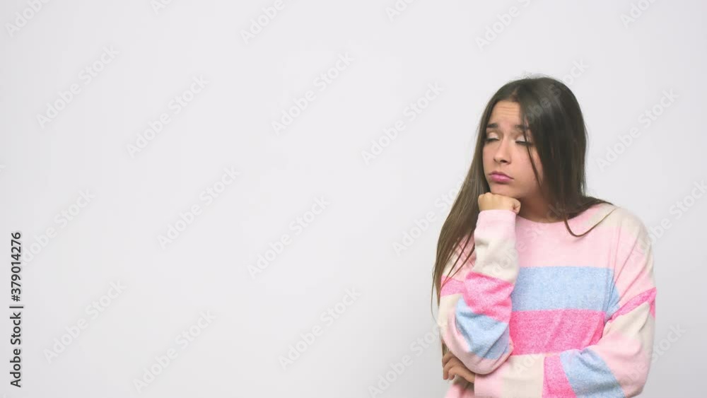 Young cute woman who feels sad and pensive, looking at copy space Young cute woman who feels sad and pensive, looking at copy space