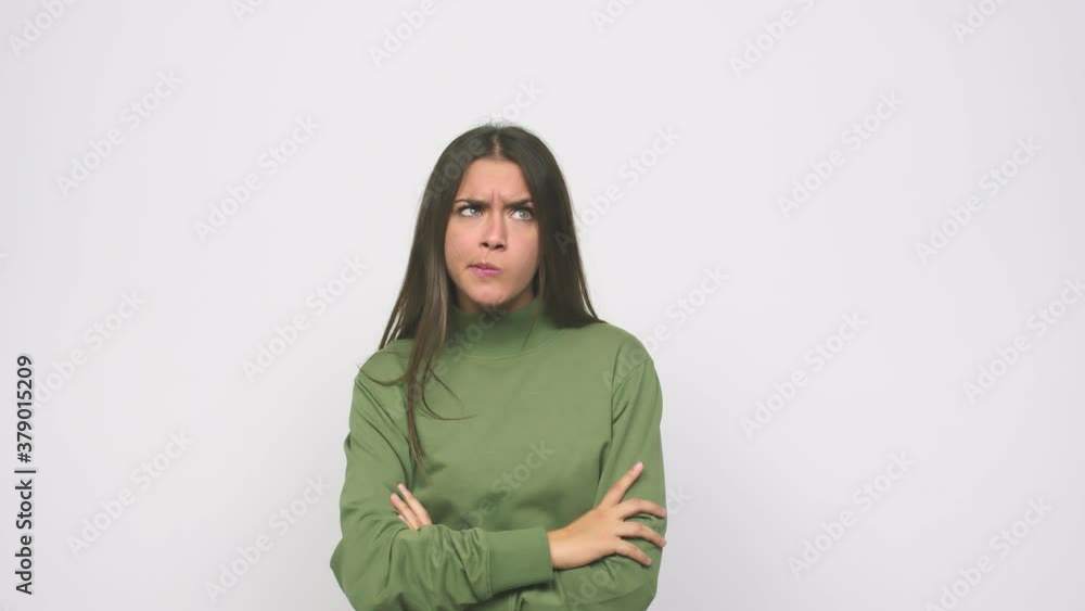Young cute woman unhappy looking in camera with sarcastic expression Young cute woman unhappy looking in camera with sarcastic expression