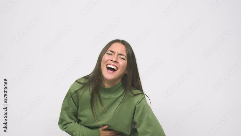 Young cute woman relaxed and happy laughing, neck stretched showing teeth Young cute woman relaxed and happy laughing, neck stretched showing teeth