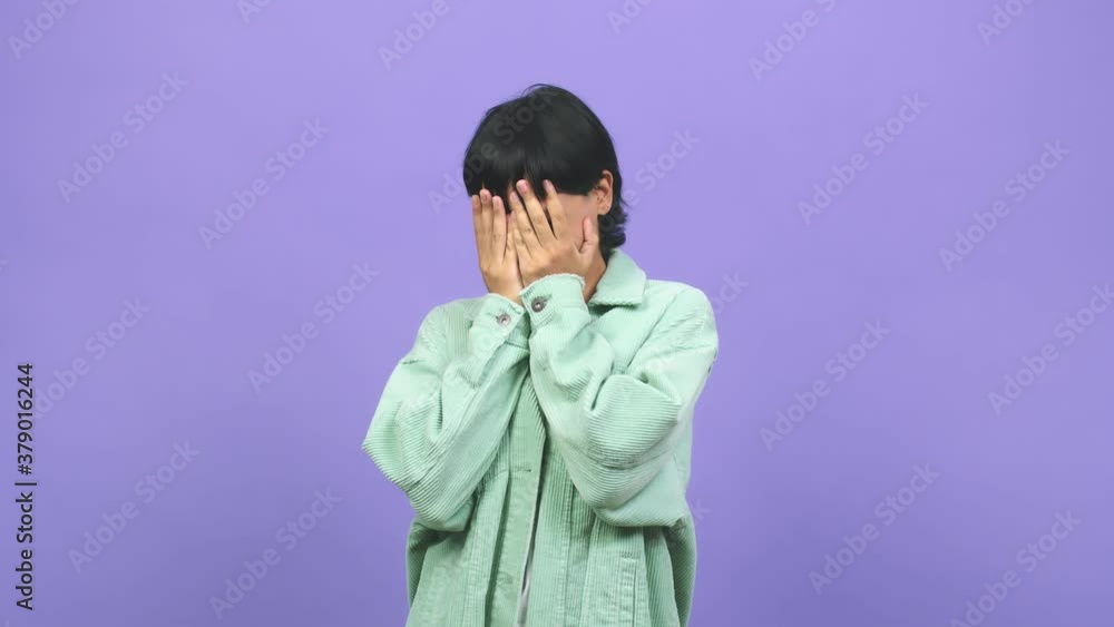 Young caucasian woman feels worried and scared, looking and covering face, concept of fear and anxiety Young caucasian woman feels worried and scared, looking and covering face, concept of fear and anxiety