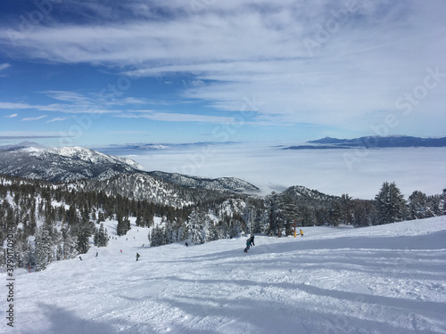 Winter landscape view over Carson Valley hidden underneath clouds, as seen from Heavenly mountain on a cloudy day