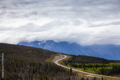 Scenic Route, Alaska Hwy, during a sunny and cloudy day. West of Whitehorse, Yukon, Canada.