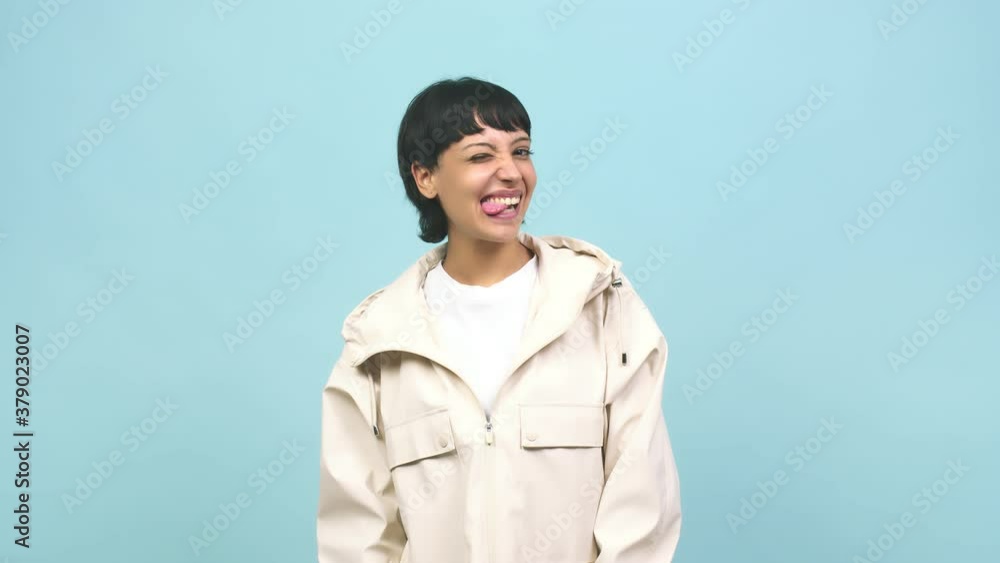 Young caucasian woman winking, funny joke, symbol of agreement or complicity Young caucasian woman winking, funny joke, symbol of agreement or complicity
