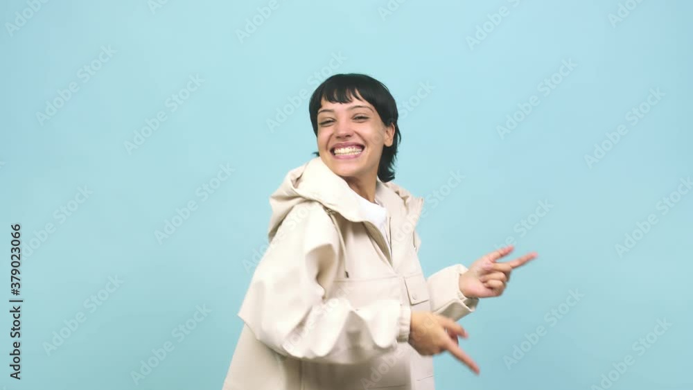 Young caucasian woman dancing and having fun, moving arms listening to music Young caucasian woman dancing and having fun, moving arms listening to music