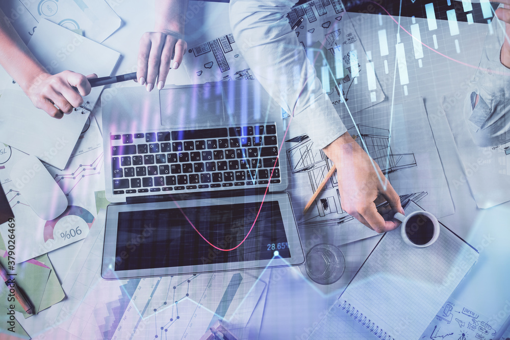 Double exposure of man and woman working together and financial graph hologram. Business concept. Computer background. Double exposure of man and woman working together and financial graph hologram. Business concept. Computer background.