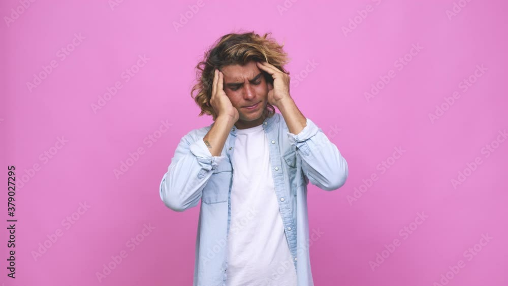 Young cool australian man touching temples and having headache Young cool australian man touching temples and having headache