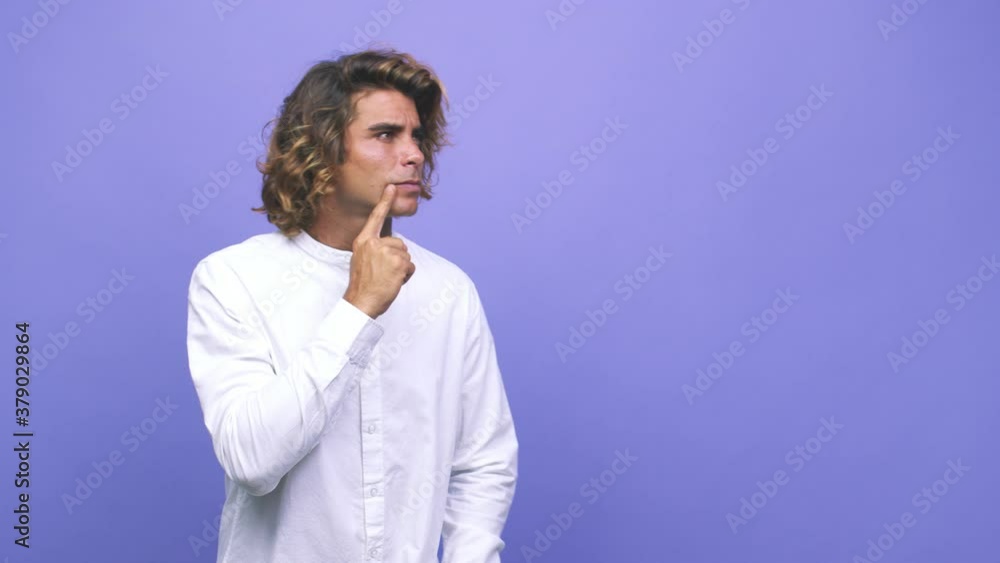 Young cool australian man looking sideways with doubtful and skeptical expression Young cool australian man looking sideways with doubtful and skeptical expression