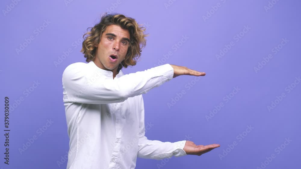 Young cool australian man shocked and amazed holding a copy space between hands Young cool australian man shocked and amazed holding a copy space between hands