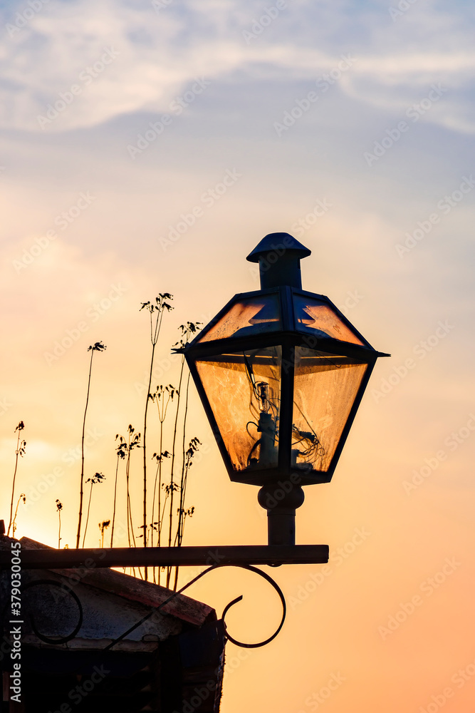 Old street lighting with lantern in colonial style during sunset in the city of Ouro Preto