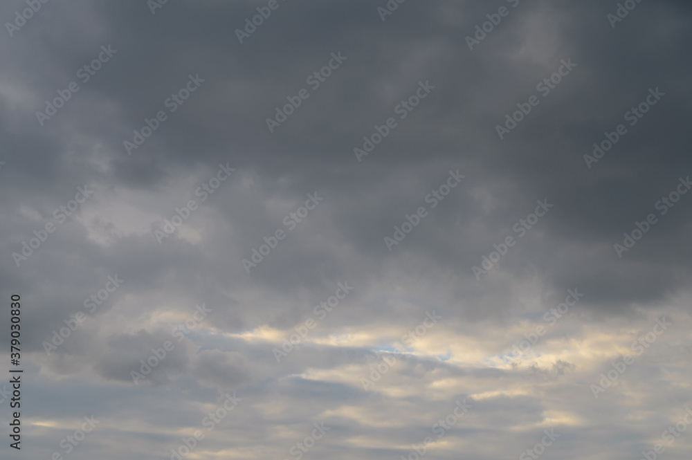 Obraz premium Abstract background of gray fluffy clouds on a bright blue sky