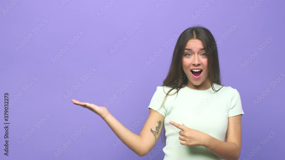 Young cute woman excited holding a copy space on palm Young cute woman excited holding a copy space on palm