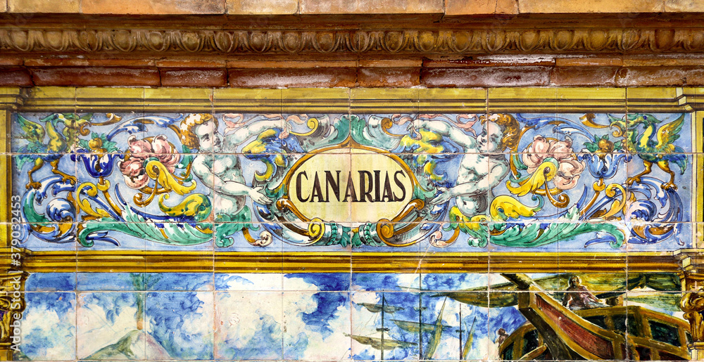 Obraz premium Tile with the name of the spanish Canary Islands on ceramic with a colorful decoration located in Spain Square in Seville