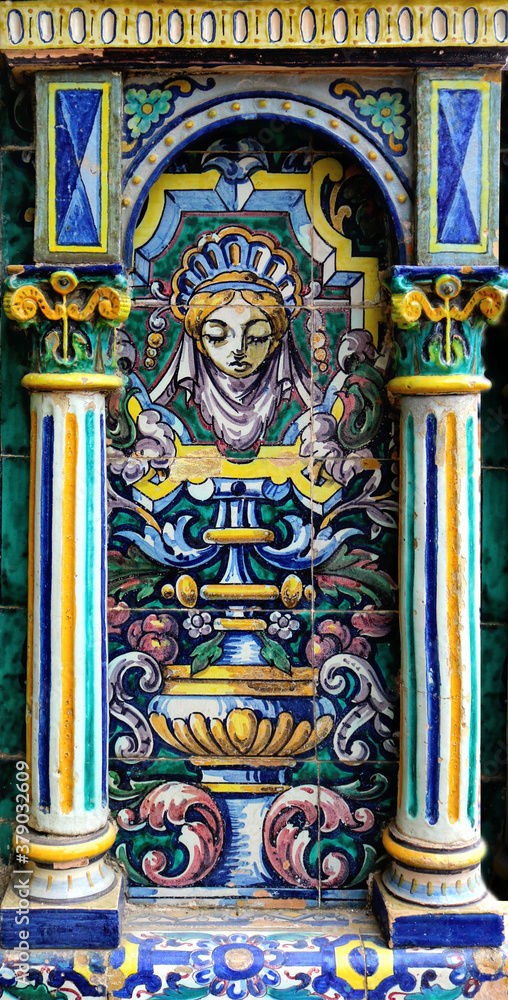 Decorative traditional style of the art of Seville with ornate ceramic image of a girl in blue, yellow, and white in the background framed by two columns