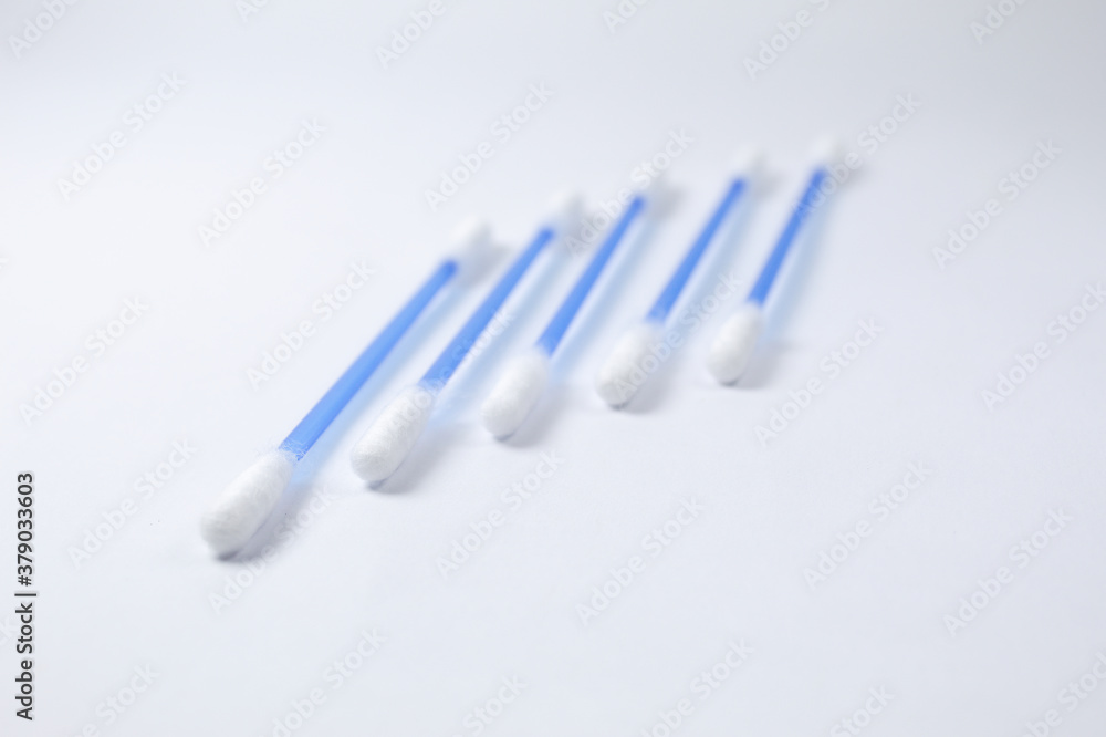 Cotton swab with white background and blue stem Cotton swab with white background and blue stem