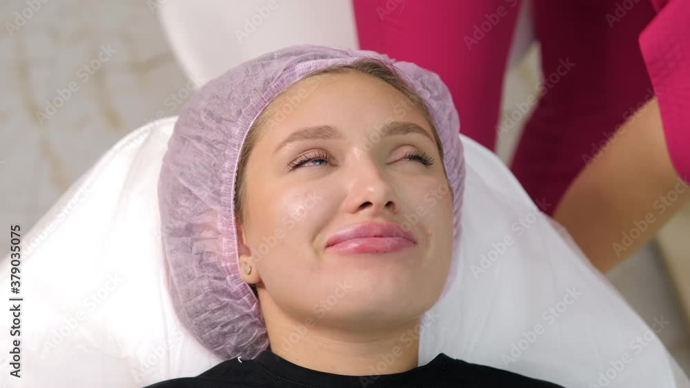Lips cosmetology. Young woman face and doctor hand in glove with syringe making injection Lips cosmetology. Young woman face and doctor hand in glove with syringe making injection