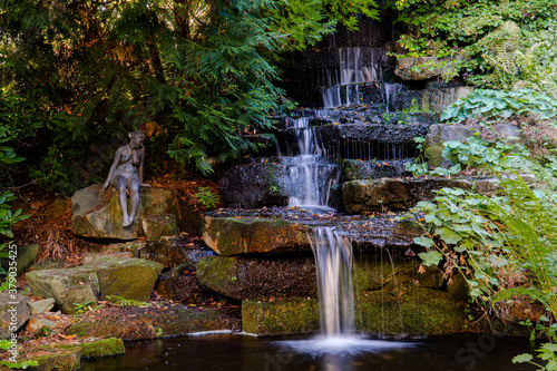 flowing gardening waterfall in peaceful natur