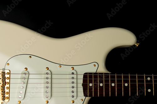 Close up of Olympic white guitar on black background