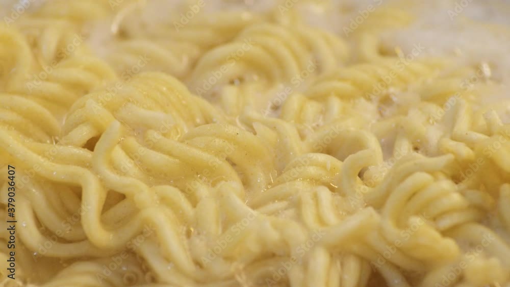 Macro Shot Of A Ramen Noodles On A Bubbling And Boiling Water. - close up, slow motion Macro Shot Of A Ramen Noodles On A Bubbling And Boiling Water. - close up, slow motion