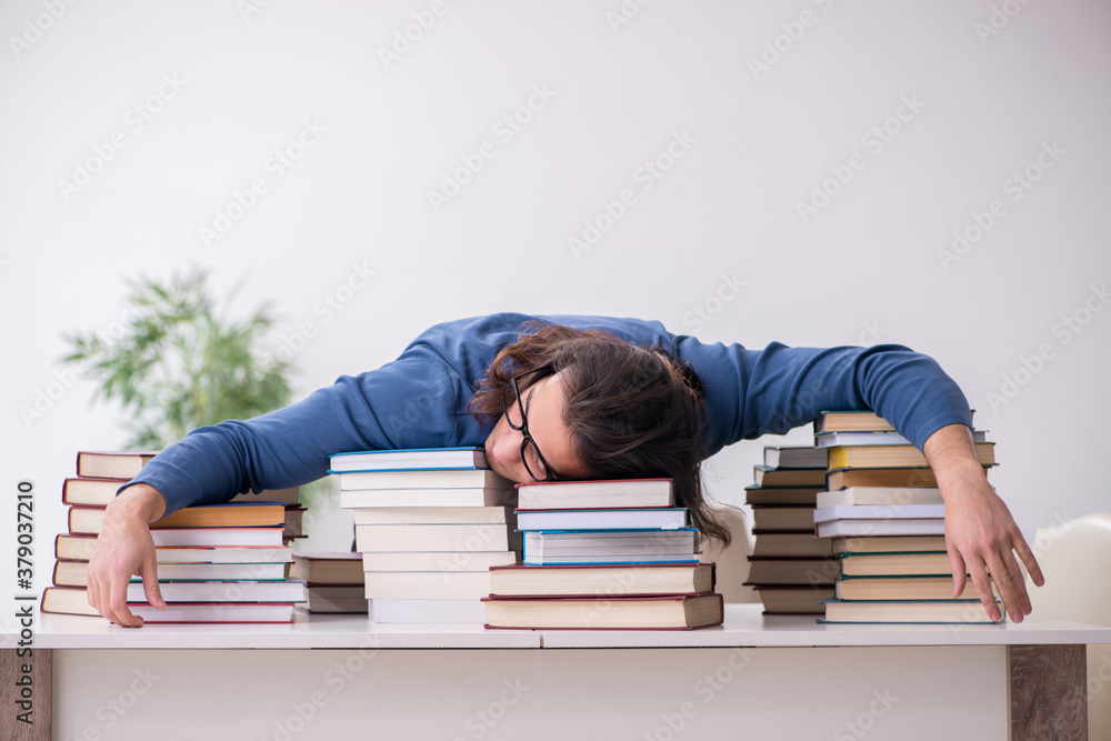 Young male student preparing for exams at home
