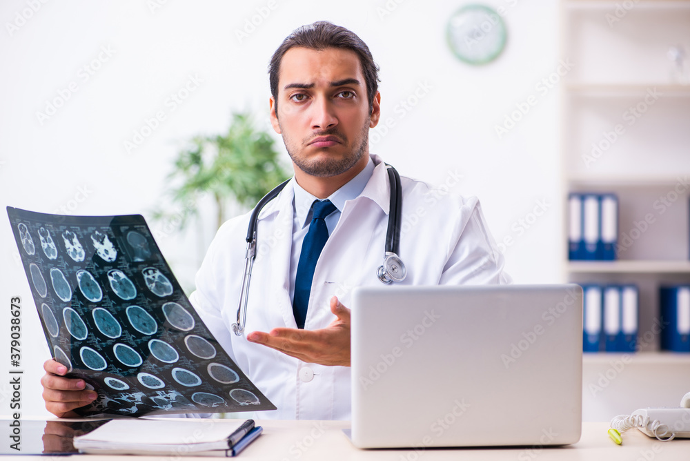 Young male handsome doctor working in the clinic Young male handsome doctor working in the clinic