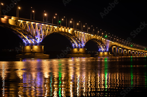 The bridge across the river glows at night