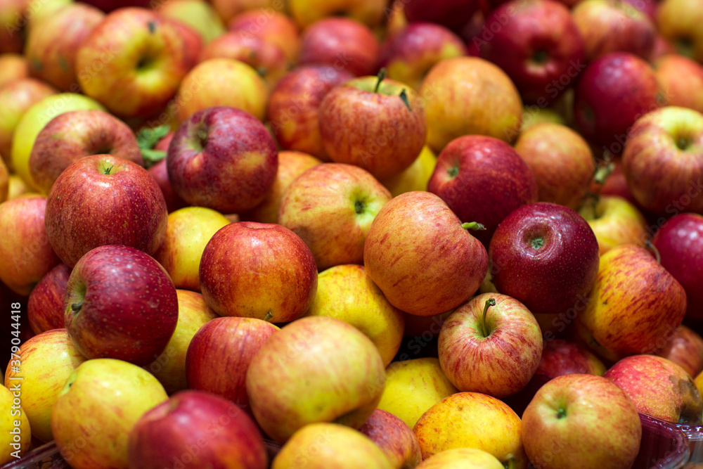 Background of apples fruits. Selective focus. Fresh Juicy apples Heap on Market Stall red apples in the market. Blurred background. Background of apples fruits. Selective focus. Fresh Juicy apples Heap on Market Stall red apples in the market. Blurred background.