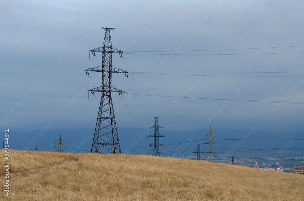 Electric pylons with wires, Power lines branch off towards the city Electric pylons with wires, Power lines branch off towards the city