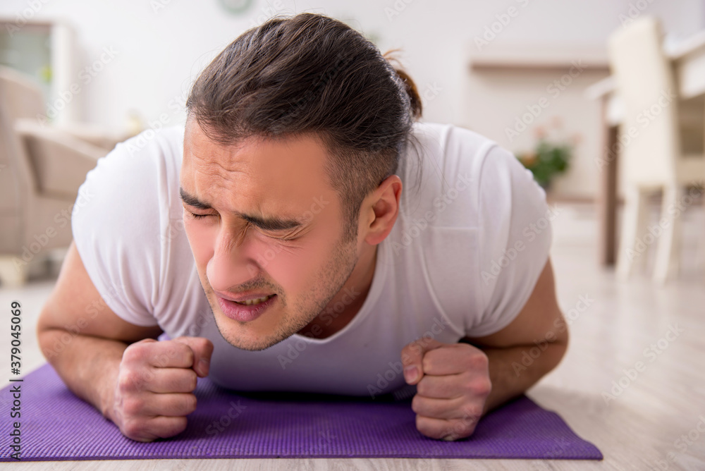 Young male starting day with morning exercises Young male starting day with morning exercises