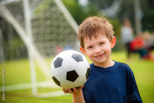 Young boy with soccer ball before game