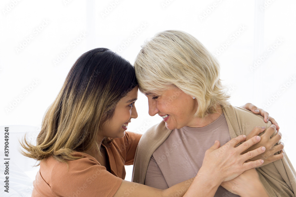 Happy mix skin family living together, asian daughter and adopted caucasian mother cuddle each other with smiles. Concept of love and sharing time of family, mother or daughter in law. Happy mix skin family living together, asian daughter and adopted caucasian mother cuddle each other with smiles. Concept of love and sharing time of family, mother or daughter in law.