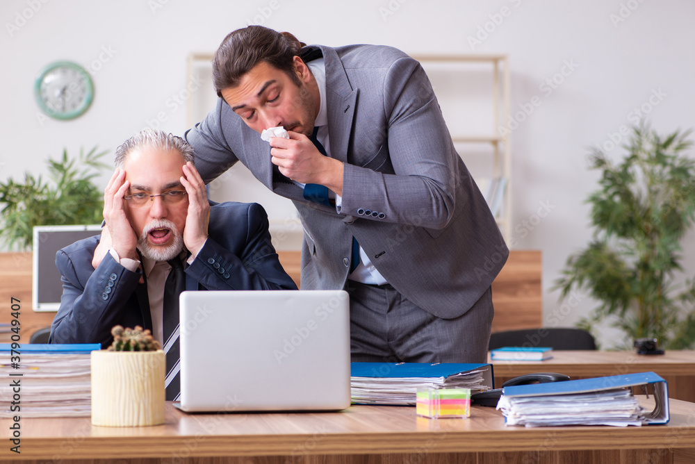 Two employees in pandemic concept at workplace Two employees in pandemic concept at workplace