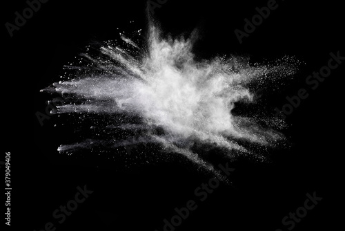 Explosion of white powder isolated on black background. 