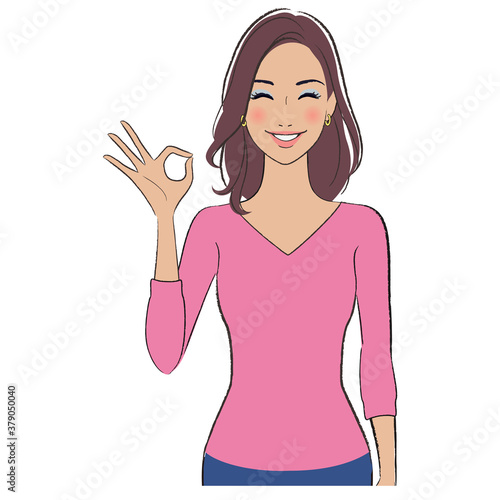 A beautiful woman with brown skin smiling and showing ok sign