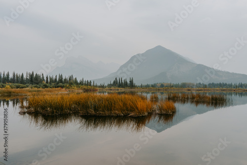 Landscape view of Vermillion Lakes in fall/autumn colors, water reflection of mountains on background and iconic mount Rundle, Banff National Park, Banff, Canada, Alberta