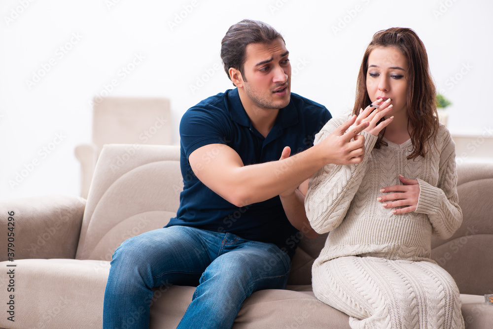 Man and pregnant woman in antismoking concept Man and pregnant woman in antismoking concept