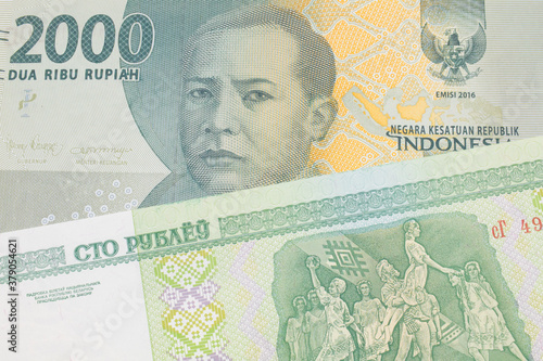 Wallpaper Mural A macro image of a grey two thousand Indonesian rupiah bank note paired up with a green one hundred ruble note from Belarus.  Shot close up in macro. Torontodigital.ca
