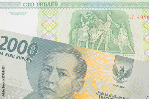 Wallpaper Mural A macro image of a grey two thousand Indonesian rupiah bank note paired up with a green one hundred ruble note from Belarus.  Shot close up in macro. Torontodigital.ca