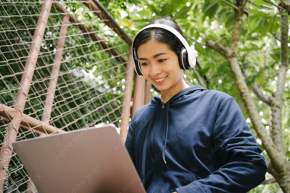 Attractive Asian Thai woman happy working and studying on her laptop outside of coffee shop, business freelance portrait. Attractive Asian Thai woman happy working and studying on her laptop outside of coffee shop, business freelance portrait.