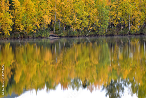 Autumn trees reflected in the water of Reflections Lake