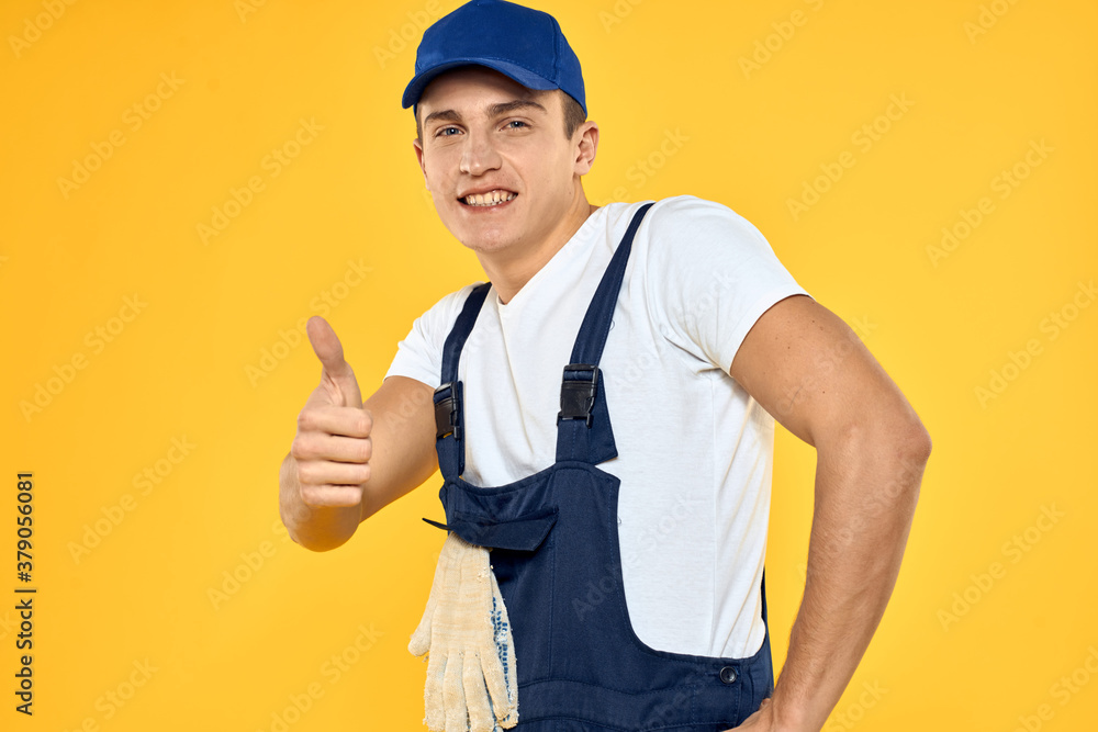 Man in working uniform emotions rendering service delivery service yellow background