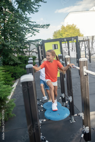 Kids playing together in jungle gym and feeling excited