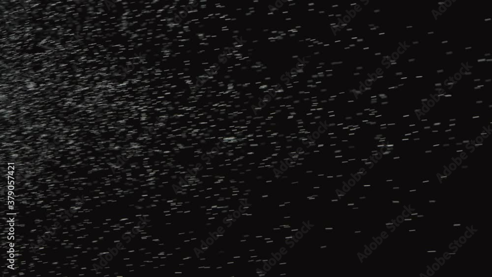 A cloud of dust particles dynamically floats with a turbulent wind on a black smoky background. Close up. Slow motion. A cloud of dust particles dynamically floats with a turbulent wind on a black smoky background. Close up. Slow motion.