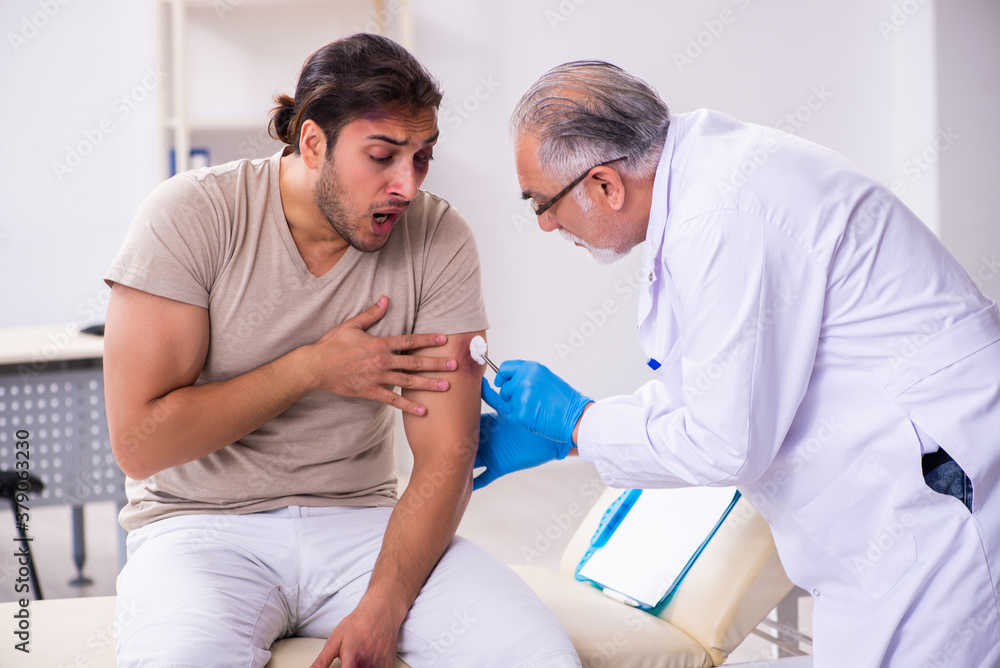 Fototapeta premium Young face injured man visiting experienced male doctor traumato