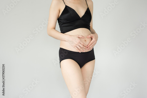 Pregnant woman in dress holds hands on belly, Pregnant woman,