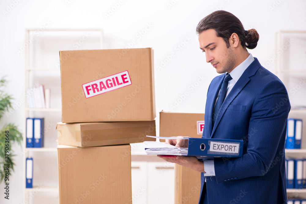 Young male logistics specialist working in the office Young male logistics specialist working in the office