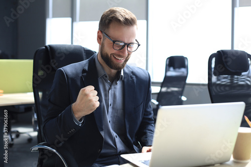 Smiling young business man having video call in office.